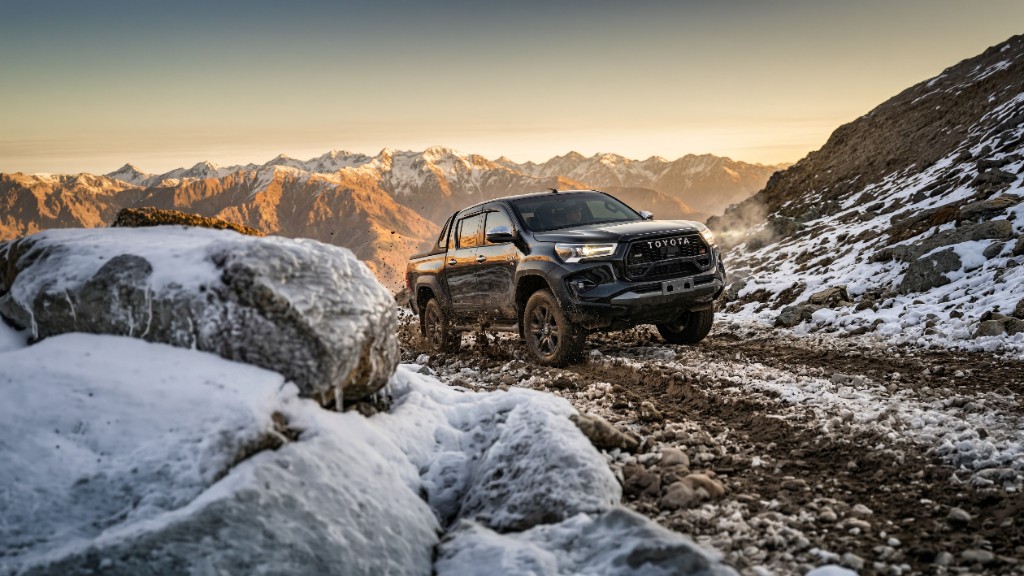 Tan Toyota Land Cruiser in desert terrain with Sentinel Titans branding